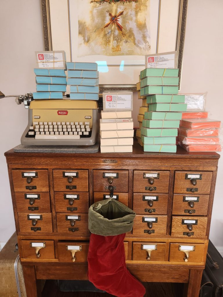 A library card catalog covered in stacks of Brodart index cards.