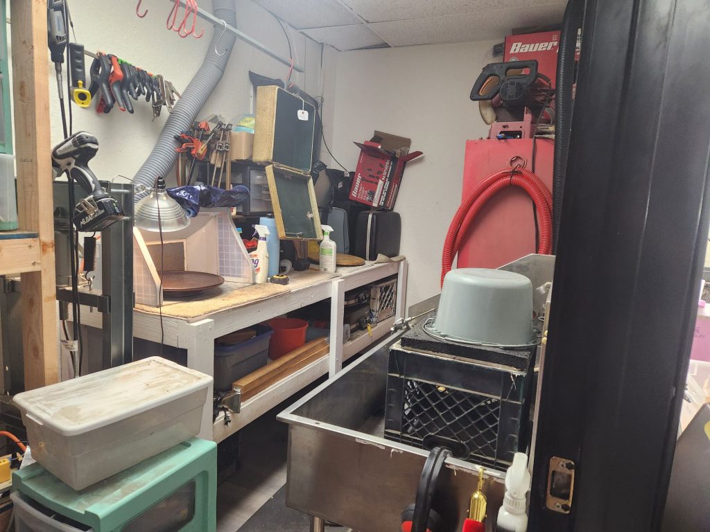The rear washroom at Typewriter Muse for cleaning typewriters including a sink and an air filtration station