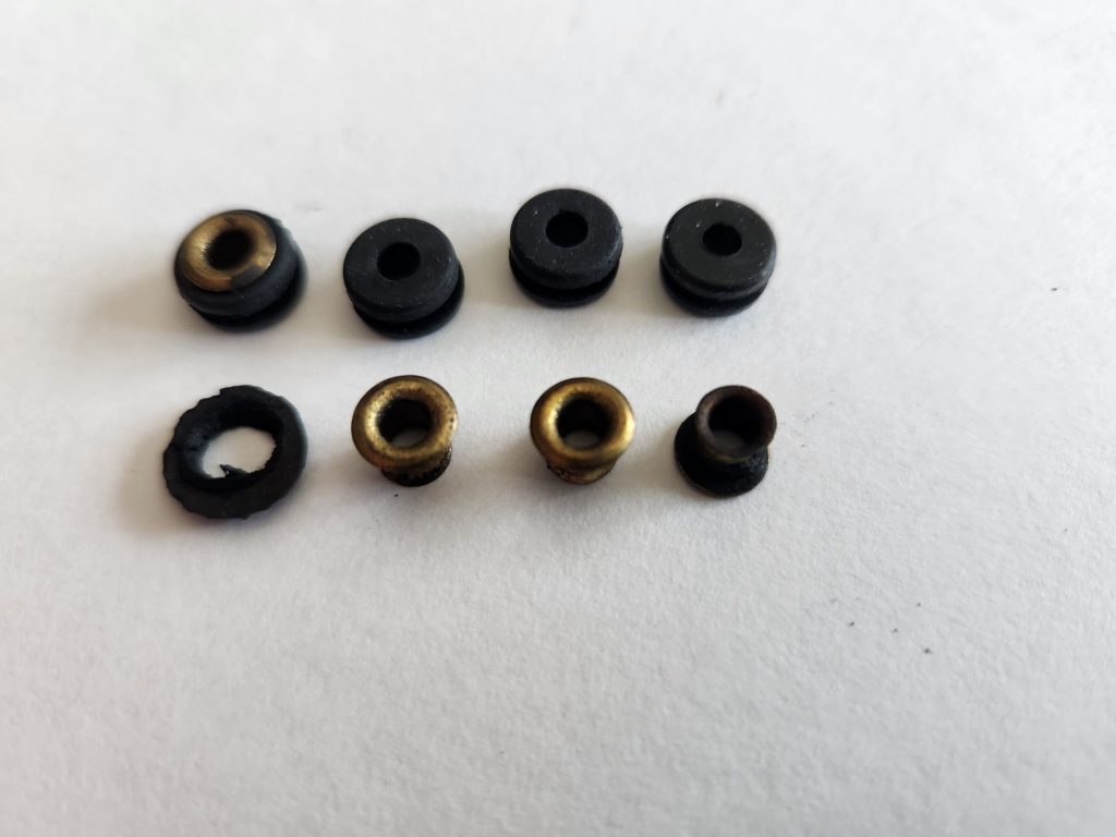 Two rows of rubber grommets and brass eyelets.