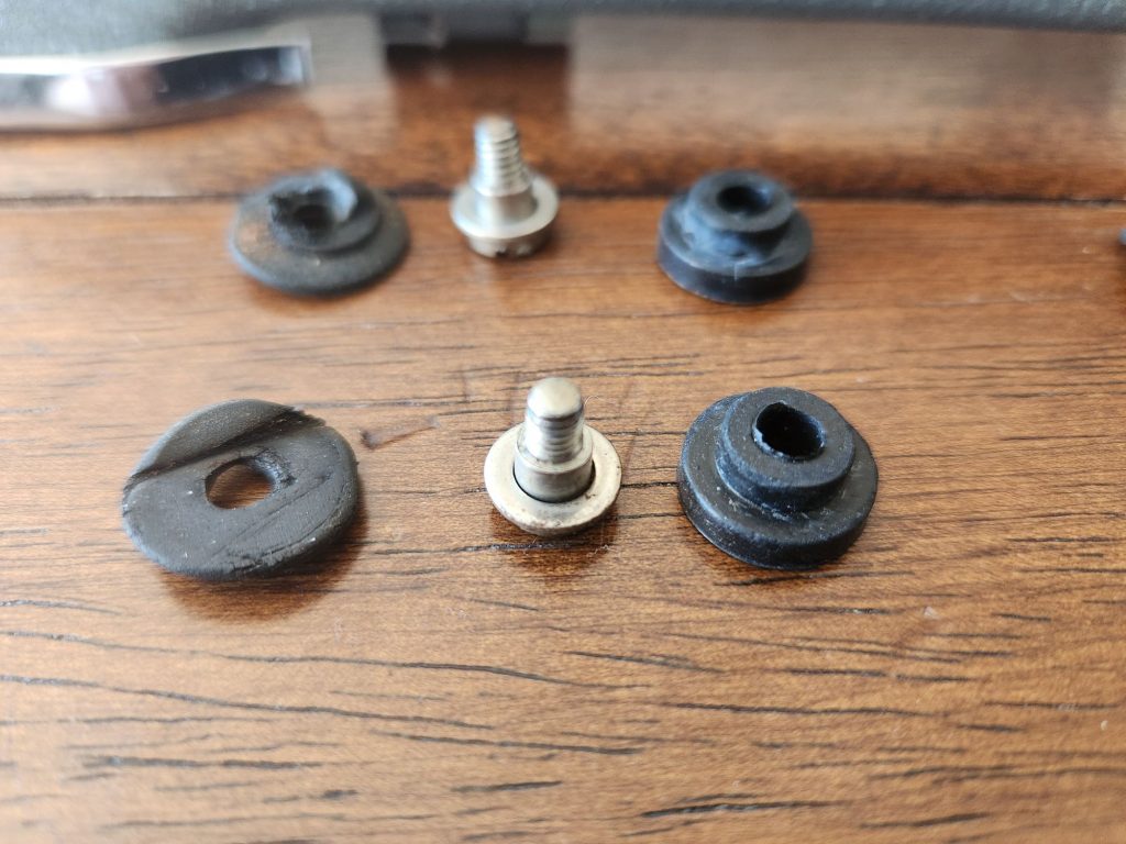 Comparison of the old bushings on the left with the new rubber bushings on the right separated by the shoulder bolts and washers in the middle.