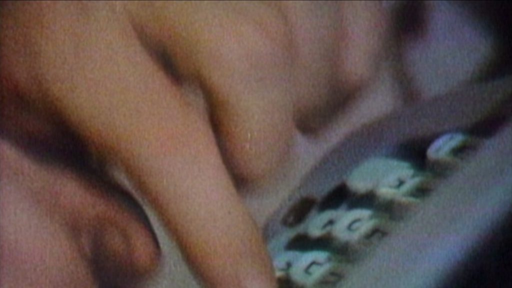 Bill Buckley's fingers typing out an article on the mint green keys of a Hermes typewriter