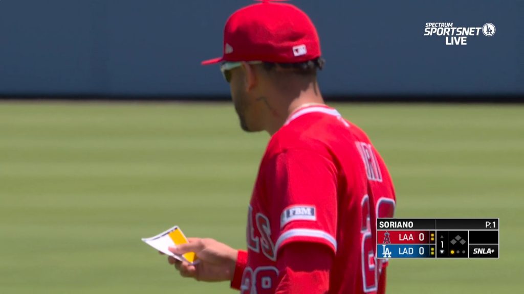 Siri with his index card back in hand returns to his position in center field