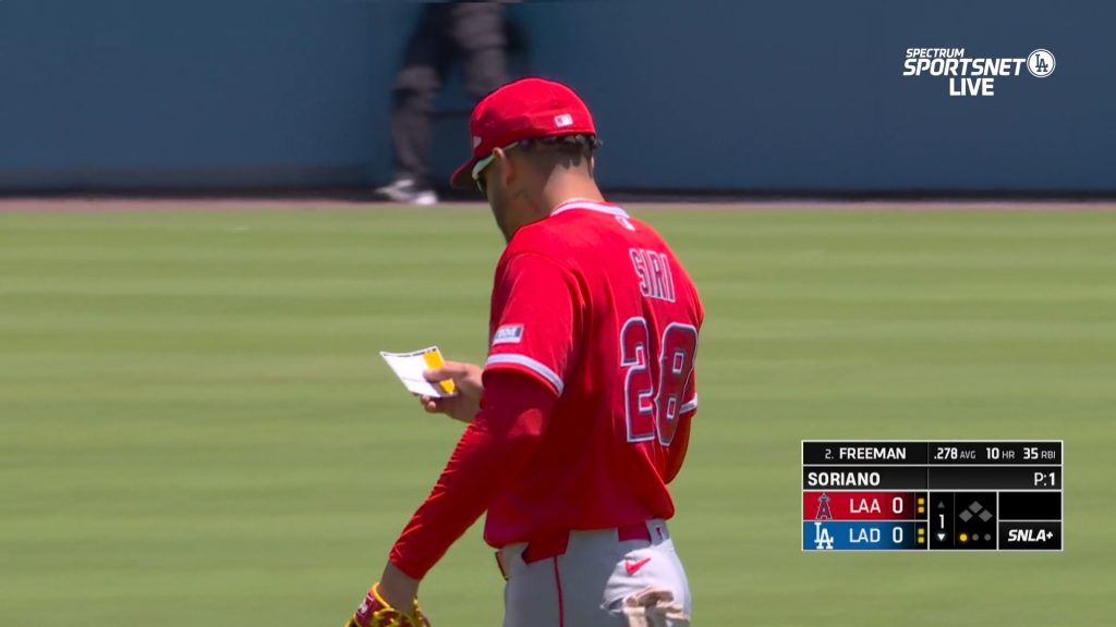 While he's got it out, Siri studies the white index card as he's walking back to his position for the next batter.