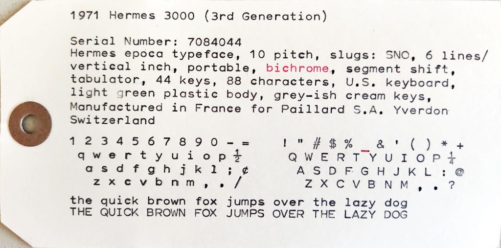 yellowish card tag featuring the san serif epoca typeface sample of a 1971 Hermes 3000 typewriter