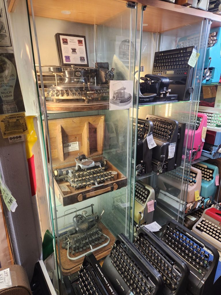 Glass display cases with antique typewriters