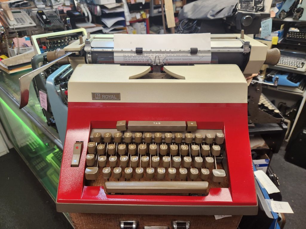 Frontal view of a Red and cream Royal (Triumph-Adler) R 700 typewriter