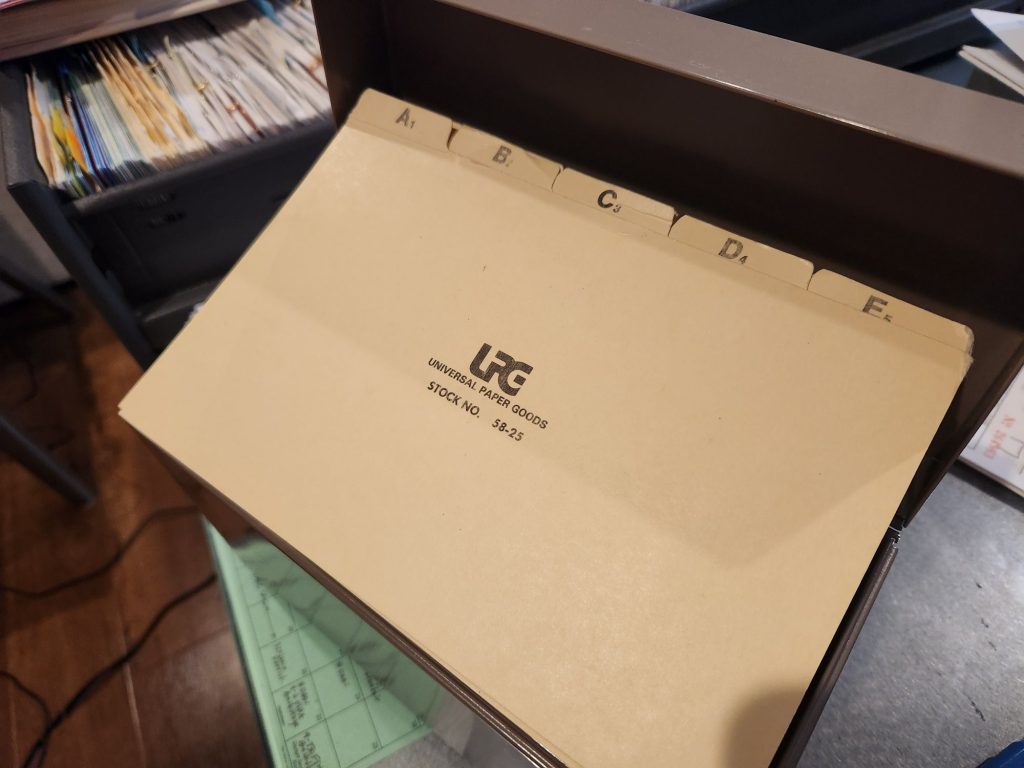A set of 1/5 cut tabbed 5 x 8 inch dividers with the UPG logo and the title Universal Paper Goods Stock No. 58-25. The visible tabs are labeled A 1, B 2, C 3, D 4, and E 5 which will allow for both alphabetic filing as well as filing monthly by date.